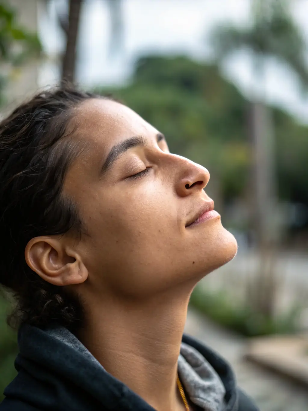 A close-up shot of a person's peaceful face during a yoga session, emphasizing mental serenity and mindfulness at YOGA ARC EN CIEL DE L'AUBOIS.